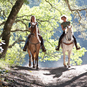 Two women horseback riding